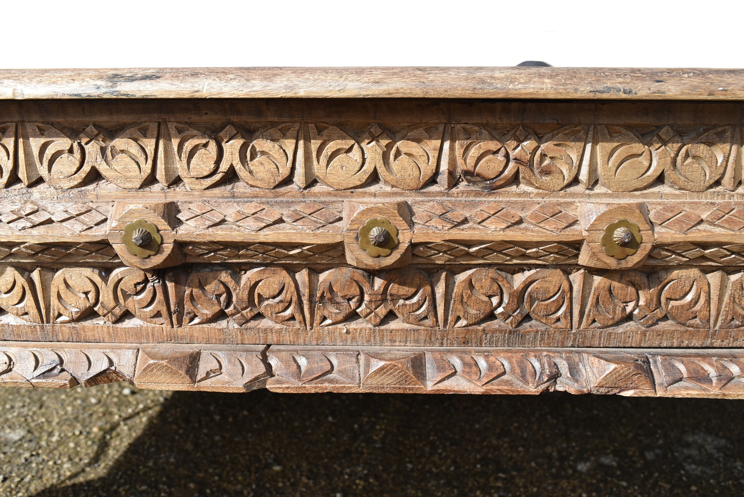 A large Indian teak carved and metal bound low table. - Image 7 of 8