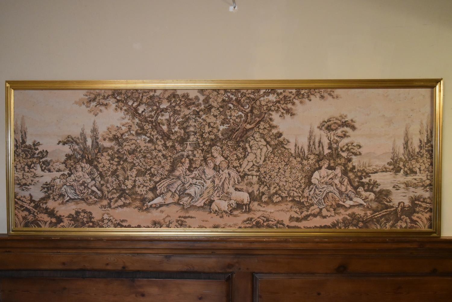 A large gilt framed Aubusson style wall hanging of a garden courting scene. H.75 W.204cm