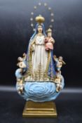 A 20th century hand painted ceramic 'Virgen Caridad del Cobre', on a square stepped base. H.50 W.