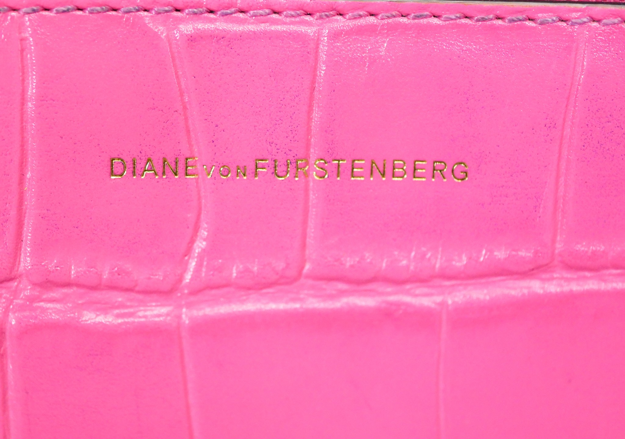 A neon pink Diane Von Furstenberg embossed leather crossbody bag. Brass Hardware and gilded name. - Image 5 of 9