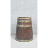 A 19th century brass bound coopered oak tapering barrel. H.55 Dia. 40cm