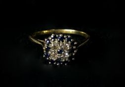 A vintage sapphire and diamond 18 carat gold cluster ring. Set with four round eight cut diamonds in