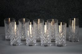 A set of nine hand cut crystal highball glasses with stylised foliate design. H.15cm