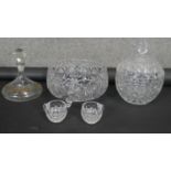 A large cut crystal punch bowl with two punch cups, a lidded crystal bowl and gilded crystal