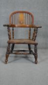 A 19th century fruitwood Windsor armchair with elm seat on turned stretchered supports. (Lower splat