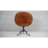 A Georgian figured mahogany tilt top occasional table on turned tripod cabriole base with pad