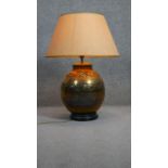 A pierced foliate design brass vase shaped table lamp with shade. H.188 D.30cm