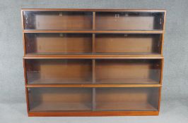 A mid century vintage teak Simplex four section bookcase with sliding plate glass doors. H.145 W.183