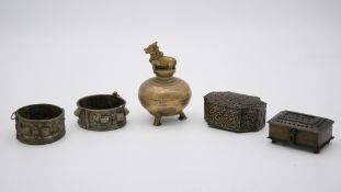 A pair of studded white metal cuffs along with two pierced design trinket boxes and a brass censer