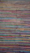 A hand finished striped multicoloured cotton carpet. 320X240