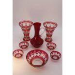 A collection of Bohemian glass. Including a pair of ruby cut to clear glass conical design vases,