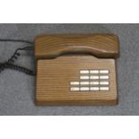 A mid-century Swiss Gfeller Trub elm telephone.