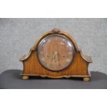 A mahogany veneered Wellington style quarter chiming mantle clock with brass movement and Roman