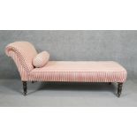 A Victorian chair back chaise longue in candy striped upholstery on turned mahogany tapering