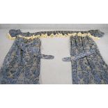 A pair of blue and gold silk mix foliate design curtains with pelmet and tie backs. Silk tassel