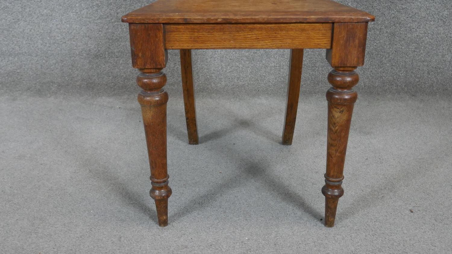 A late 19th century oak hall chair with inset Mintons tile to the back above panel seat on turned - Image 4 of 7