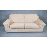 A contemporary two seat sofa in faux suede upholstery. H. 90 W. 205 D. 100