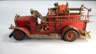 A tin plate model of a Victorian fire engine truck. Equipped with accessories.