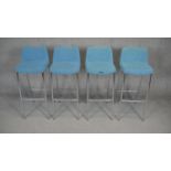 A set of four contemporary upholstered and metal framed high stools.