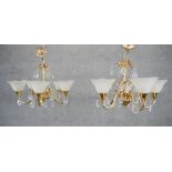 A pair of five branch chandeliers with floral design frosted shades and cut glass drops. Diam.50 CM