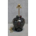 A large Eastern colourful transfer design black ceramic table lamp with brass double bulb fitting.