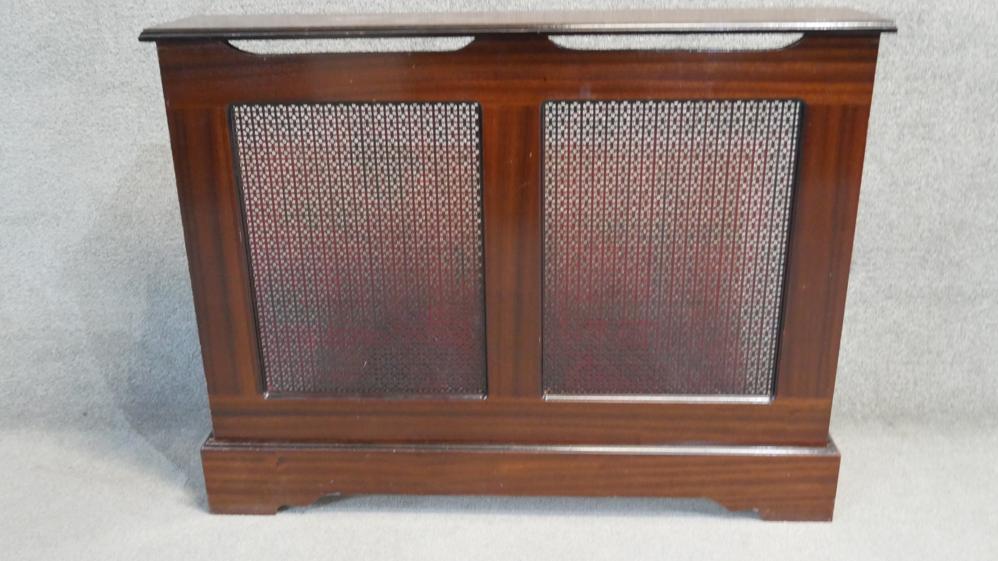 A contemporary stained teak radiator cover. H.87 W.110 D.23 CM