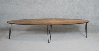 A mid century teak surfboard coffee table on metal hairpin supports. H.43 W.180 D.41cm