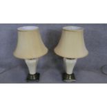 A pair of vintage brass and white crackle glaze ceramic table lamps with cream shades. H.74cm