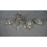 A large collection of silver plate. Including two oval lidded serving dishes with foliate design