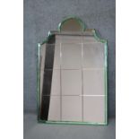 An Art Deco overmantel mirror in arched pale green glazed frame. (Two sections of green glass
