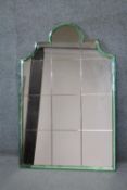 An Art Deco overmantel mirror in arched pale green glazed frame. (Two sections of green glass
