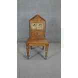 A late 19th century oak Aesthetic style hall chair with inset Mintons tiles to the back. H.100 W.