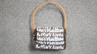 A Louis Vuitton x Stephen Sprouse graffiti pochette. With tan leather handle and embossed mark to
