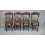 A set of four Mundus 19th century bentwood dining chairs with embossed backs and seats.