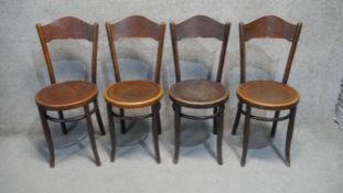 A set of four Mundus 19th century bentwood dining chairs with embossed backs and seats.