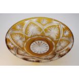 A vintage large Bohemian amber cut to clear glass bowl with a star and floral design. Diam.33cm
