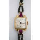 A Bucherer Art Deco gold plated ladies cocktail watch, set with pink paste baguette stones, square