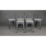 A set of six contemporary metal Tolix style dining chairs with squab cushions.