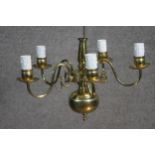 A Dutch style vintage five branch brass chandelier with scrolling design.