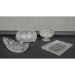 Four heavy cut crystal items. Including a crescent shaped cut crystal bowl, a rectangular tray,