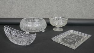 Four heavy cut crystal items. Including a crescent shaped cut crystal bowl, a rectangular tray,