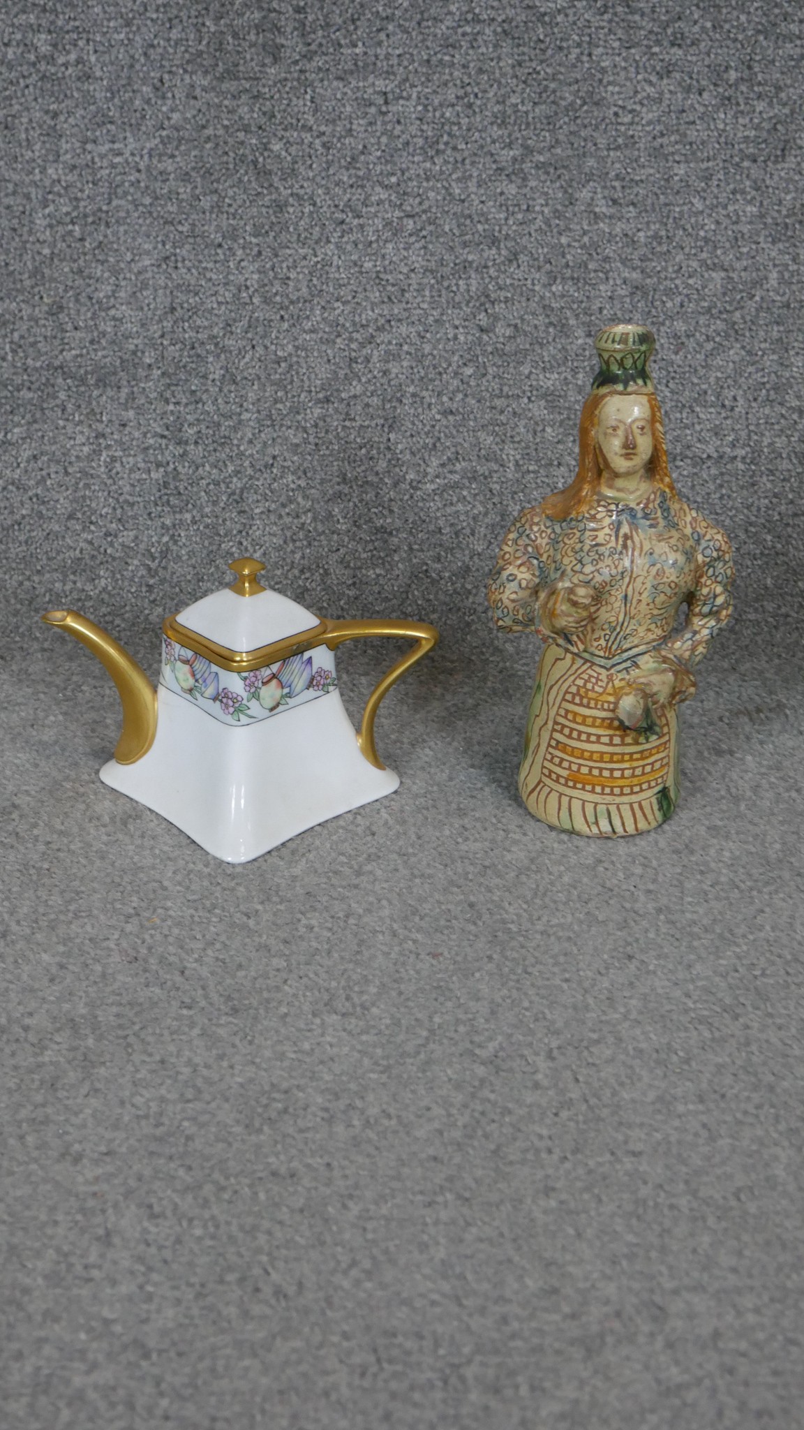 A glazed ceramic bottle in the form of a lady along with a Bavarian hand painted and gilded coffee