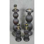 Four carved and stained table lamps with ridged bulbous design. H.60CM