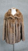 A vintage mink jacket by George Smith & Sons, Regent Street, London. Golden brown colour jacket, hip