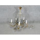 A cut crystal and gilt metal five branch chandelier with loose crystals. Diam.57 CM
