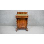 A 19th century figured walnut Davenport with brass galleried and fitted superstructure above leather