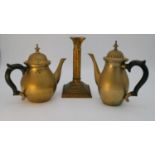 A brass ebony handled coffee pot and tea pot along with a gilt brass column design candle stick.