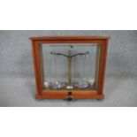 A wooden and glass cased set of brass analytical lab balance scales. H.40 W.43 D.20cm