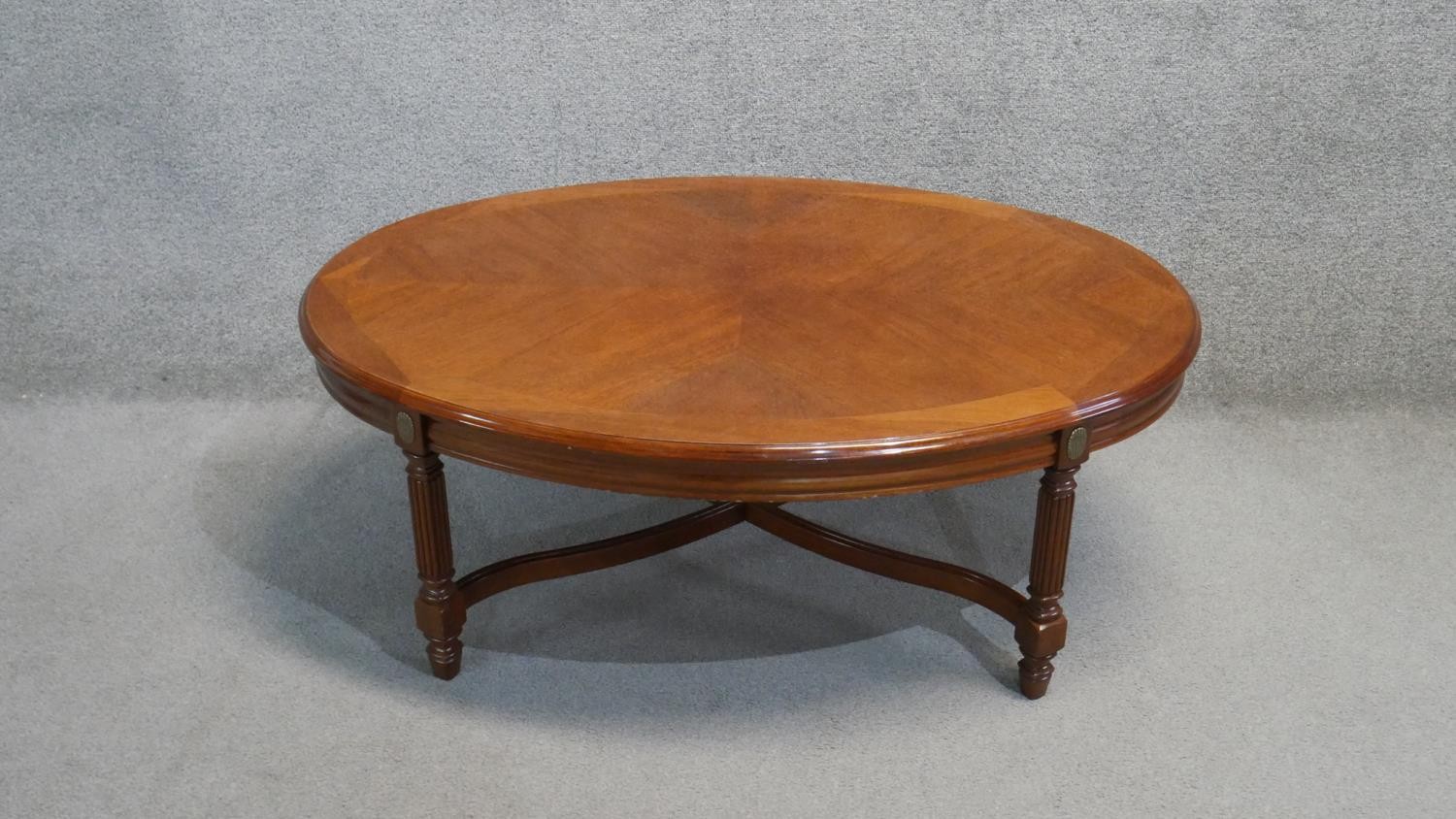A Continental walnut and crossbanded low table on reeded stretchered supports. H. 44 W. 110 D.75 - Image 2 of 4