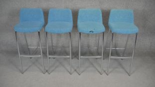 A set of four contemporary upholstered and metal framed high stools.